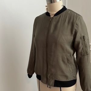 Khaki bomber jacket. 87%modal, 13% polyester. Zipper pocket detail on sleeve.